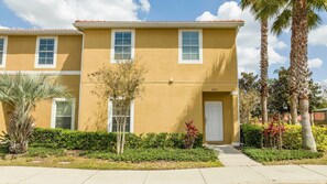 A two-story residential building with a flat roof, white-framed windows, and a door with a number '3013' on the front. - 3BR themed rooms near Disney | Private hot tub (Kissimmee)