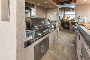 A kitchen with a built-in grill, a refrigerator, and a coffee maker. - The Naughty Flamingo Studio Camper (Bay City)
