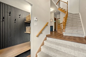 A staircase with wooden steps and a handrail, leading to a second floor. - Tremblant Prestige - Clairière 403 (Mont-Tremblant)