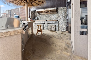 An outdoor kitchen with a grill, a stove, and a sink. - The Lady Luck In Water Docked Studio Boat Room (Bay City)