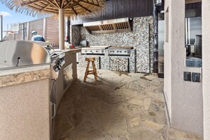 An outdoor kitchen with a grill, a stove, and a sink. - The Treasure Hunter In Water Docked Studio Boat (Bay City)