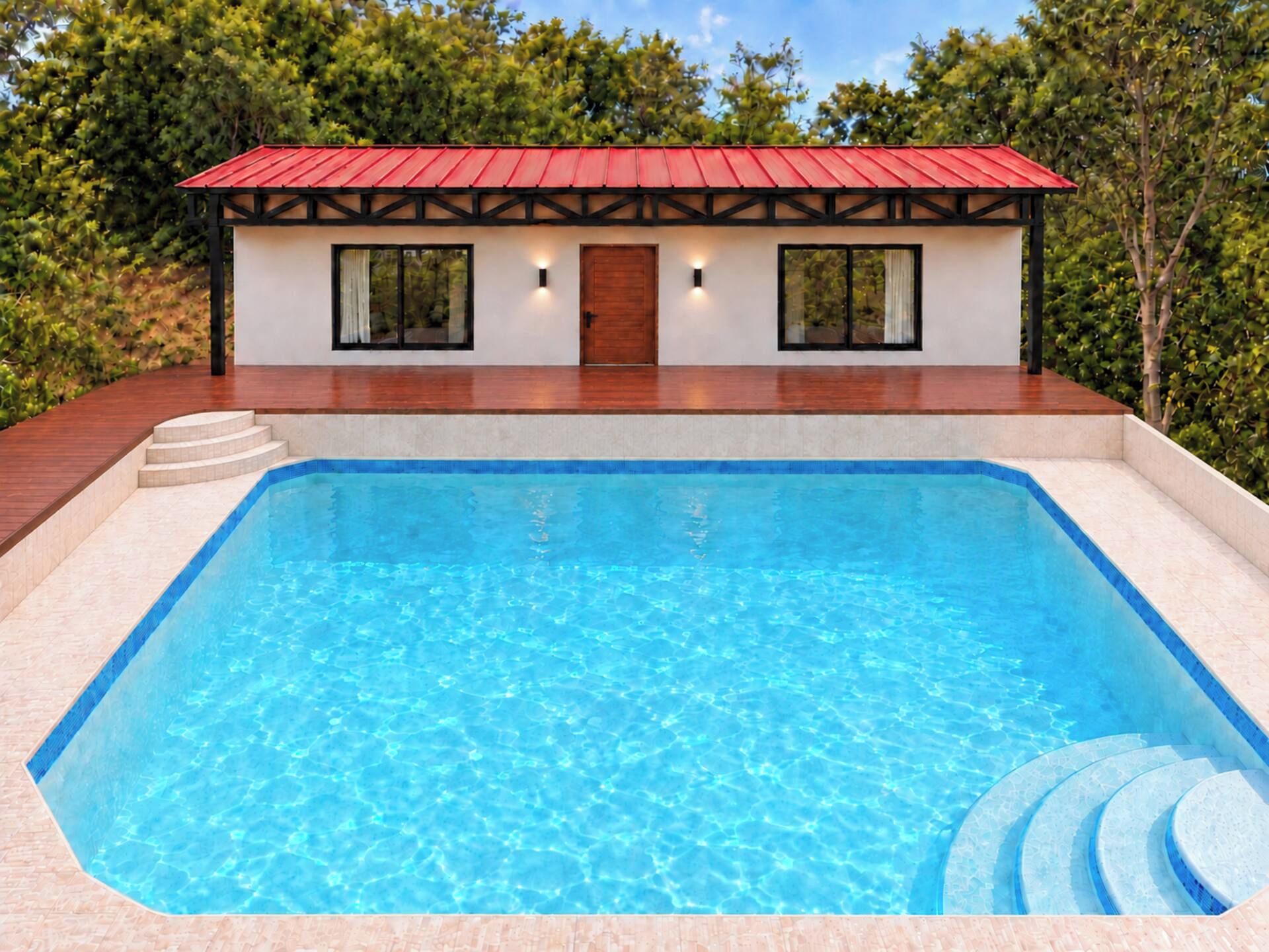 A swimming pool with a wooden deck and a building with a red roof in the background.
