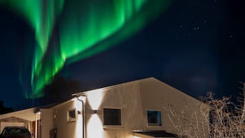 Une maison avec un garage, une allée et un lampadaire.