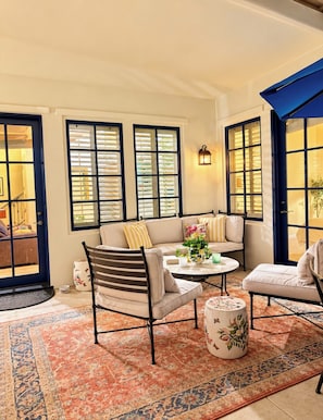 A cozy living room with a sofa, chairs, a coffee table, and a patterned rug. - A Charming Legacy Villa
3 bedroom 4 bath Steps to Pool & Stunning Mountain Views (La Quinta)