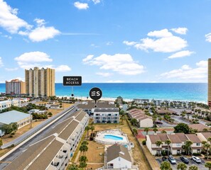 A coastal hotel with a pool, beach access, and a view of the ocean. - Coastal 2bd Condo with Community Pool and Hot Tub (Panama City Beach)