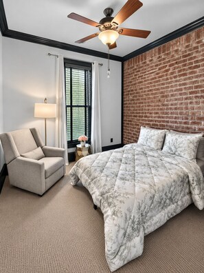 A bedroom with a bed, a chair, a lamp, and a ceiling fan. - Furnished Executive Townhome - Dedicated WFH Office - Ideal for 6+ Month Stays (Atlanta)