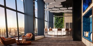A modern interior with large windows, a dining area, and a seating arrangement. - Edificio Byte Ñuñoa by Domus Travels (Ñuñoa)
