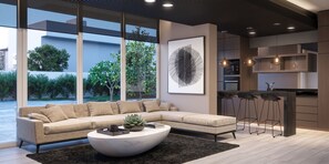 A modern living room with a sectional sofa, a round coffee table, and a large window with a view of trees. - Edificio Byte Ñuñoa by Domus Travels (Ñuñoa)