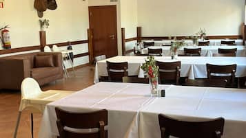 A dining area with multiple tables, chairs, and a fire extinguisher on the wall.