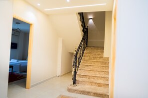 A staircase with a decorative railing leading to a landing. - Double Room with Private Bathroom (Sheikh Zayed City)