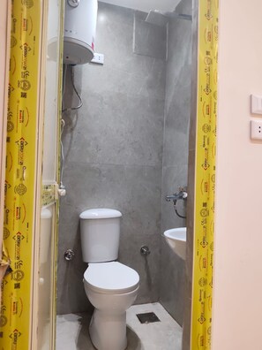 A bathroom with a toilet, a sink, and a shower enclosure. - 2099. Cozy 1BR | El Hossary | October (New October City)
