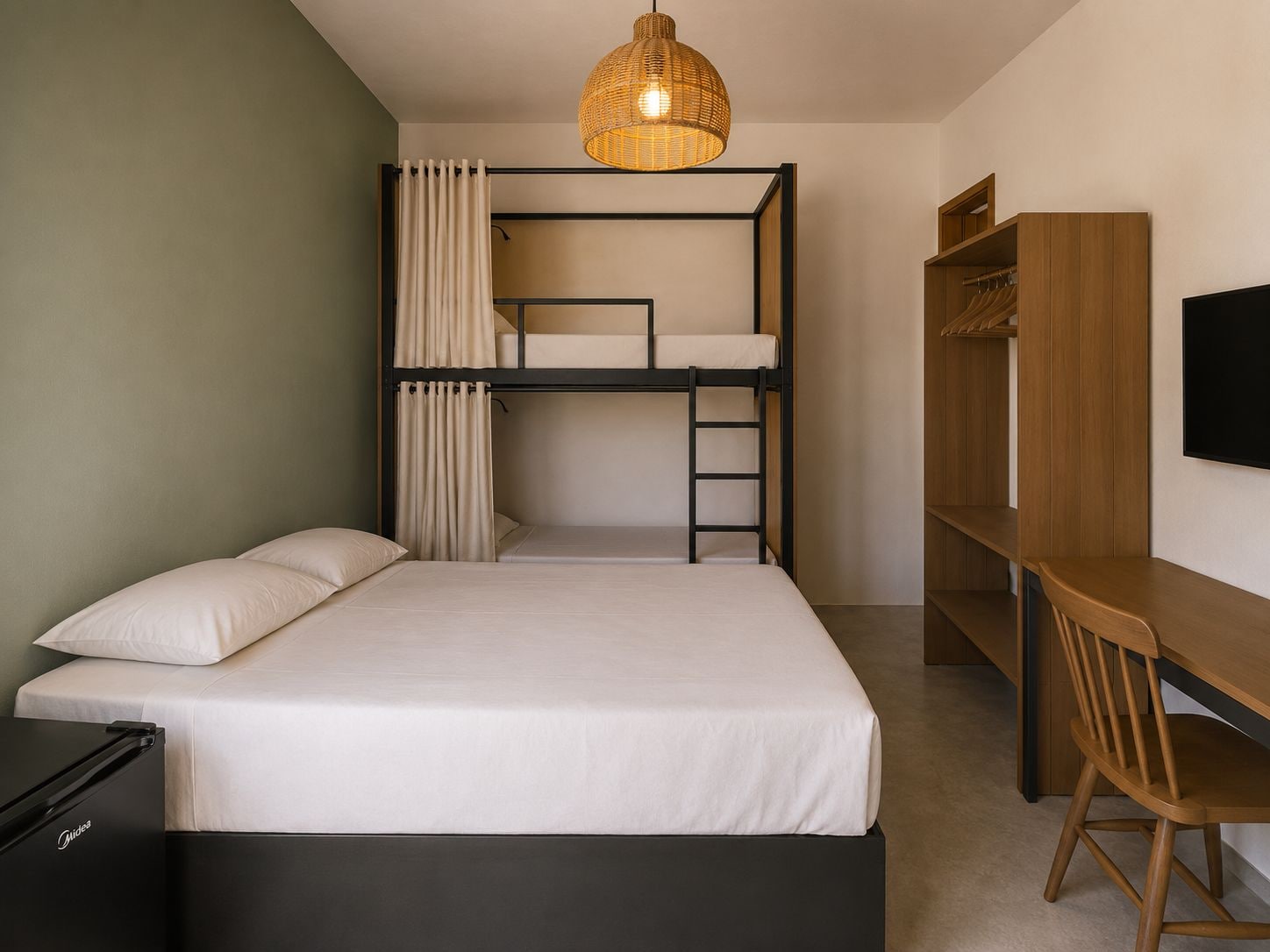 A bunk bed with a desk and chair, a television, and a wicker lamp.