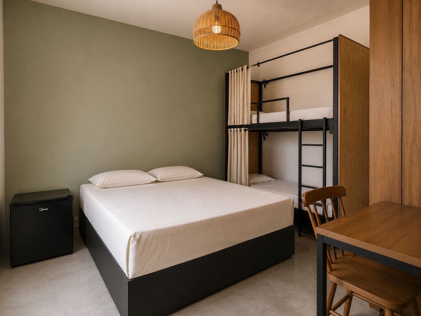 A bunk bed with a desk and chair, a small black cabinet, and a hanging light fixture.