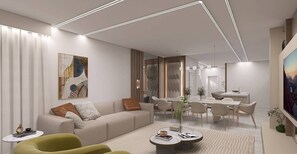 Ein modernes Wohnzimmer mit Sofa, Couchtisch und Essbereich.