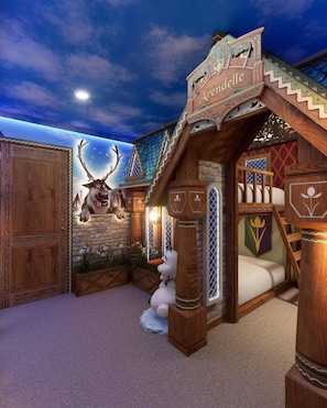 A themed room with a carved wooden sign reading 'Arendelle,' a stone wall, a bed, and a reindeer figure. - Brand New 8BR | Disney-Themed Home (Clermont)