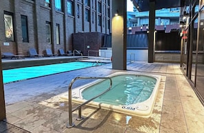 A swimming pool area with a hot tub and lounge chairs. - Stylish 1bed 1bath | pool|gym | Central (Toronto)
