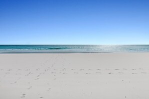 A beach with footprints leading to the water, clear sky, and calm sea. - St Croix's Finest ☀️Remodeled 3BR Beachfront⛱️HGTV Worthy🐟Silver Shells😎Amenities🌴 (Destin)