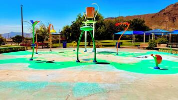 A playground with colorful structures and a clear blue sky.