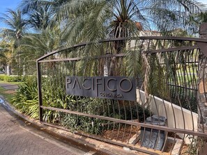 A gated entrance with a sign that reads 'PACIFICO Costa Rica.' - The Resort Life- Pools, Beach Club, Gym, King Bed (Playas Del Coco)