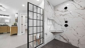 A modern bathroom with a shower, a vanity, and a large mirror. - Take it to the Bank by Avantstay Lakefront + Pool + Spa Dock + Kayaks Elevator Access (Denver)