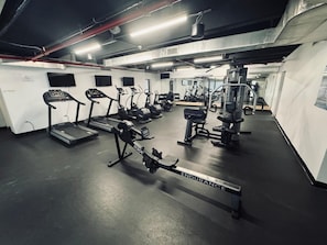 A gym with treadmills, elliptical machines, and weightlifting equipment. - The best view in Isla Verde (Carolina)
