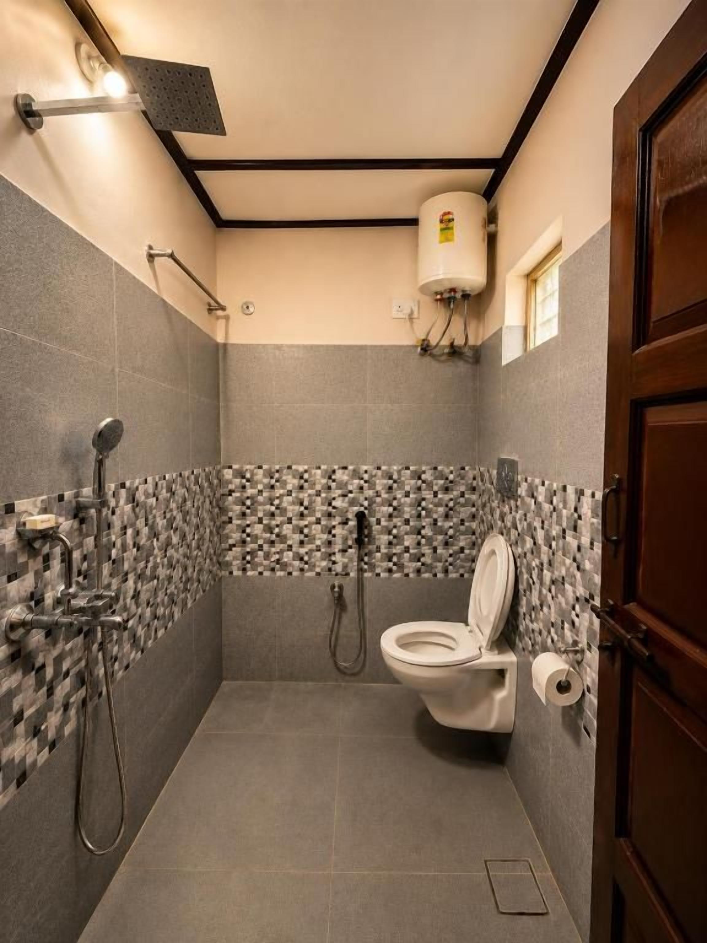 A small, compact bathroom with a toilet, a shower, and a towel rack.