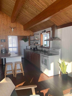 A kitchen with wooden cabinets, a central island, and a built-in oven.