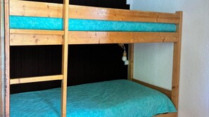 A bunk bed with a teal mattress and a white wall. - 350m from ski slopes, 1st floor, balcony, tv, ski locker, 30m², Valloire (Valloire)