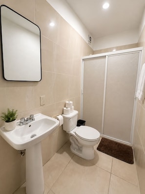 A bathroom with a white sink, toilet, and shower. - Cozy apartment Independencia condo with AC in vibrant Puerto Vallarta (Puerto Vallarta)