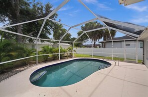 A swimming pool with a white roof structure, surrounded by trees and a clear sky. - COMING SOON !!
Tremendous 3-bedroom house with pool in North Port (North Port)