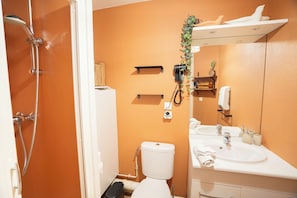 A bathroom with a white toilet, a sink, and a shower. There are shelves and a mirror above the sink. - Thank you, Annecy - Private Parking / Near the Lake - Soleidor (Annecy)
