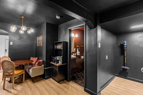 A modern interior with a dining area, a built-in kitchen, and a bathroom. - Bungalow 15 min to Downtown & Cherokee St (St. Louis)