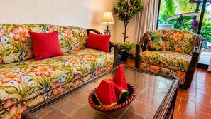 A room with a floral sofa set, a glass coffee table, and a potted plant. - Where Tropical Gardens Meet Poolside Paradise—Villa Jenny (Manzanillo)