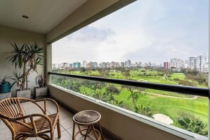 A balcony with a view of a cityscape and a golf course. - Coronel Portillo Residences By Geko (San Isidro)