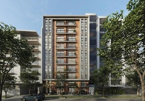 A modern multi-story building with balconies, a car parked in front, and trees around. - Designer 2Br Perfect View Near Costa Verde By Geko (Miraflores)