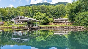 A lakeside property with a dock, a covered pavilion, and a building with a stone foundation. - Perfect Getaway on the Water~Beautiful Gorge Views~11 miles to Downtown! (Chattanooga)