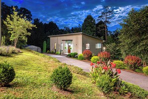 A single-story building with a flat roof, a front entrance, and a small porch. - Pickleball, Game Room, Firepit, Putt putt, Hot Tub (Leicester)