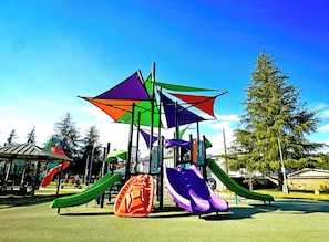 A playground with multiple slides and a climbing structure. - Gated bungalow · work desks · fast WiFi · parking (Los Angeles)