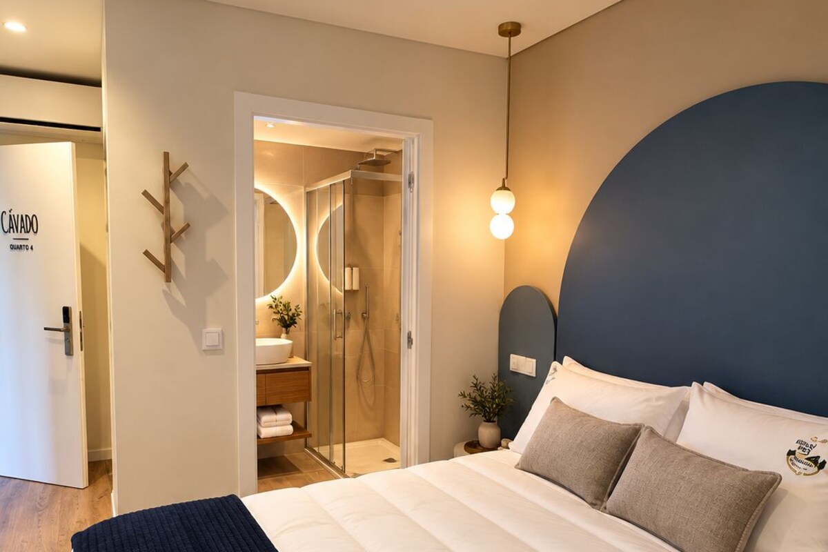 A bedroom with a bed, bedside table, and a nightstand.
