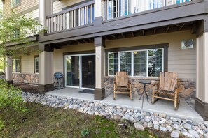 A building with a covered patio area featuring outdoor seating and a grill. - Ground Level | On Bus Route | 3 SmartTVs | Updated (Steamboat Springs)