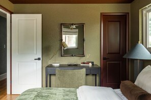 A room with a bed, a desk with a chair, a mirror, and a lamp. - Denver Dream Retreat w/Hot Tub, Sauna, Movie & Game Rms, Putting Green, Fire Pit (Arvada)