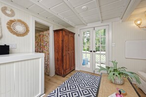 A room with a wooden cabinet, a patterned rug, and a door leading outside. - NEW! Romantic country retreat in the heart of wine & hunt country (Upperville)
