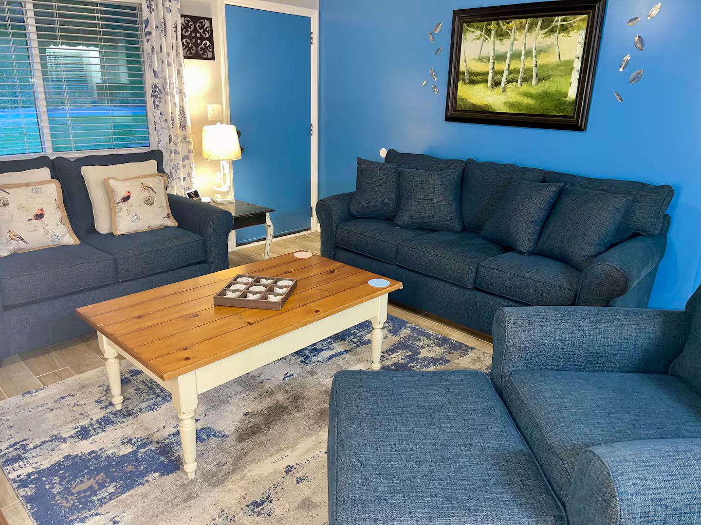 A living room with two sofas, a coffee table, and a rug.