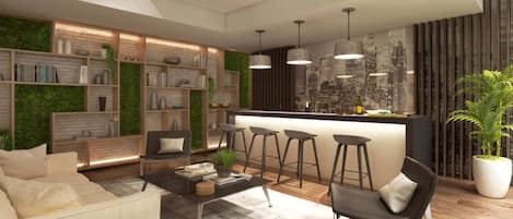 A modern living room with a sofa, coffee table, and bar stools. There is a bookshelf and a green wall.