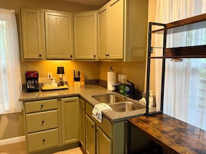A kitchen with a sink, countertop, and cabinets. - Lower Level Mountain Loft (Hot Springs)