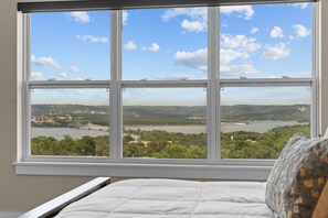A bedroom with a large window overlooking a river and a bridge. - Table Rock Lake Views | 10BR Lodge Sleeps 30 (Kimberling City)
