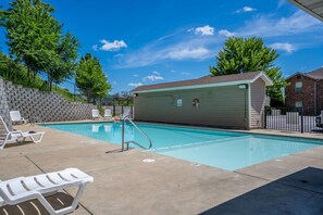 A swimming pool with lounge chairs and a covered area. - Magnolia Cottage-Walk In-Steps away from Pool-2 miles to Branson Strip (Branson)