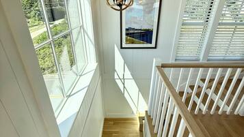A staircase with white railings and wooden steps leading to an upper level.