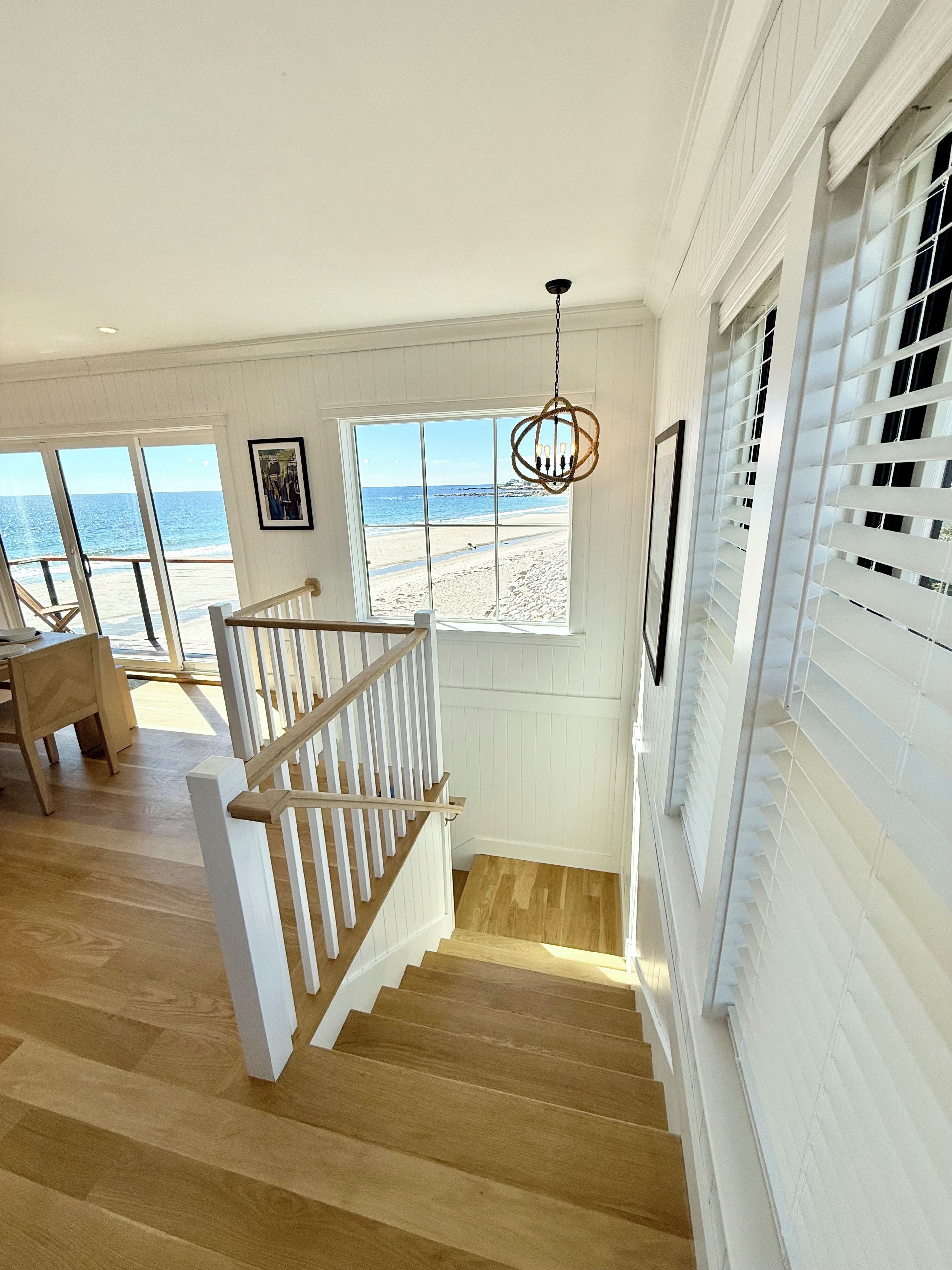 A staircase leading to a balcony with a view of the beach.