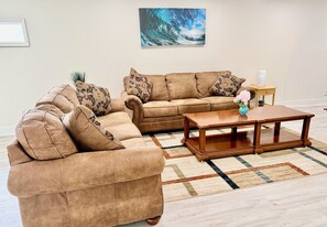 A living room with a sectional sofa, a coffee table, and a rug.